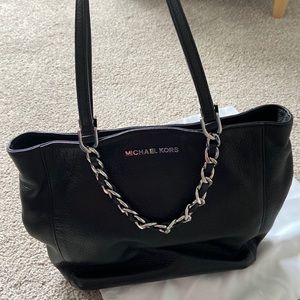 Black tote with shoulder straps and silver handle